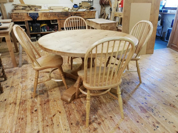 Swailes round oak dining table with braced pedestal in workshop