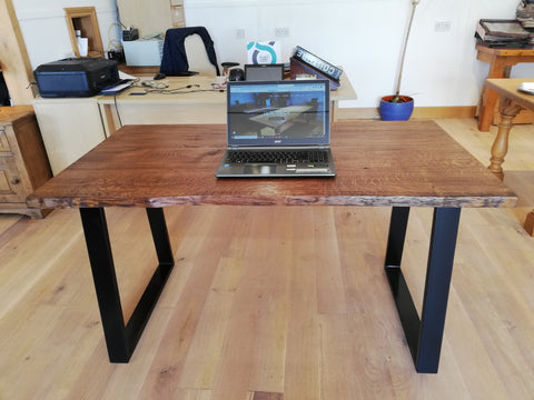 Oak desk top with live edge on a powder coated steel base