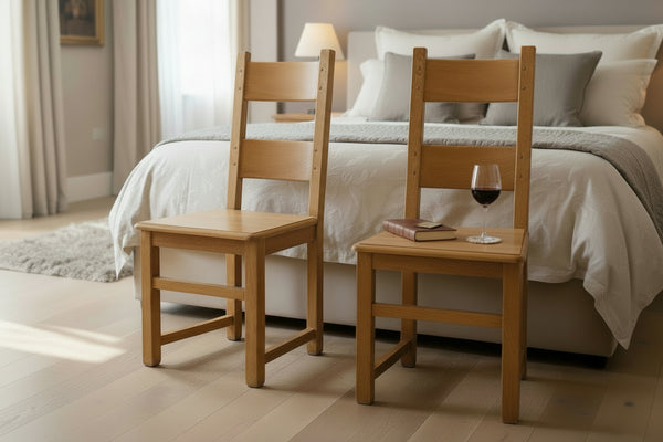 Two wooden chairs in a room with tables and chairs in the background.