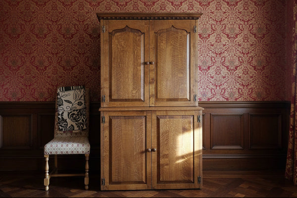 Wooden cabinet with two upper and two lower doors in a room setting.