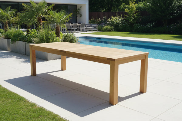 Cannes Garden Oak Table planked top on a modern luxury patio beside a swimming pool
