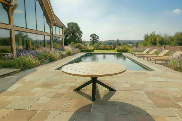 oak garden table on patio next to pool