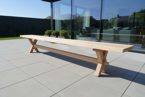 wooden Cross leg bench on a patio