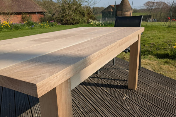 oak garden table close up with a rural view