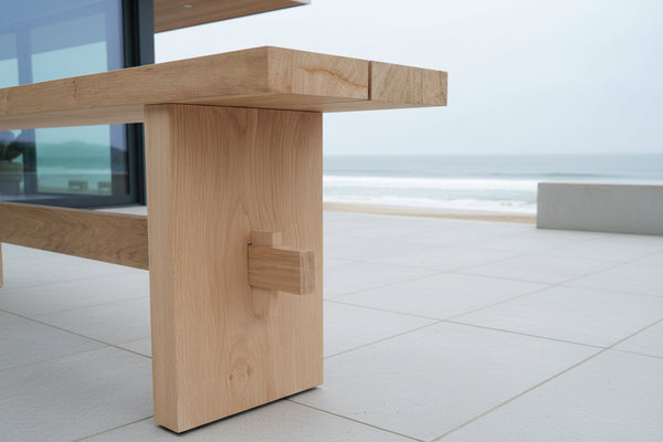 Outdoor Dining Furniture - Oak Slab End Bench on patio of beach front house
