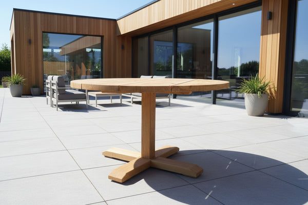 Round Dining Table on patio of modern oak clad house