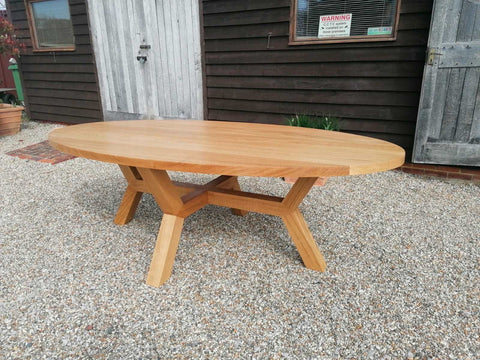 Contemporary Oval solid oak table with angled base