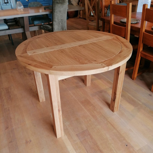 Round oak extending dining table natural lacquer finish