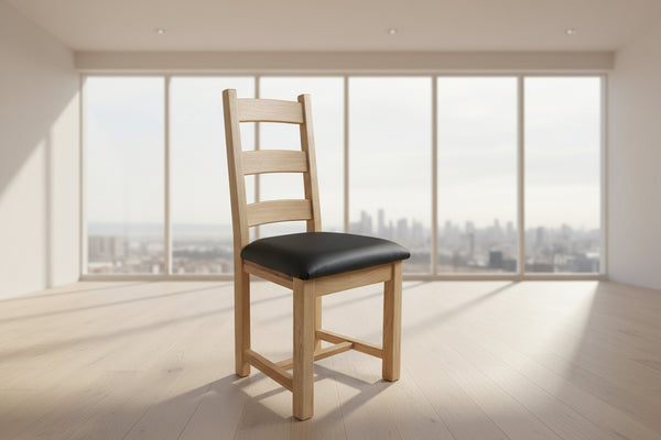Wooden chair with black seat in a room with large windows