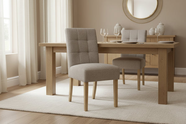Gray upholstered chair with wooden legs on a white background