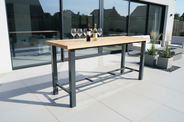Powder coated aluminium bar table with a solid oak planked top on patio 