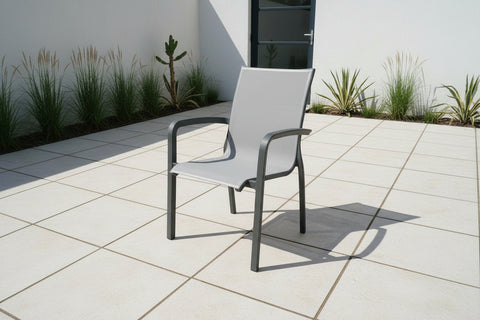 Outdoor dining chair in grey on patio