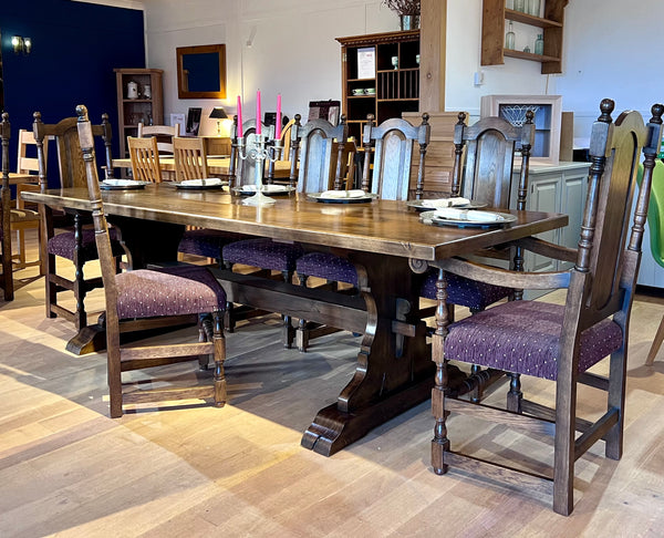 Set of 8 solid oak panel back side chairs and 2 carvers in medium dark oak