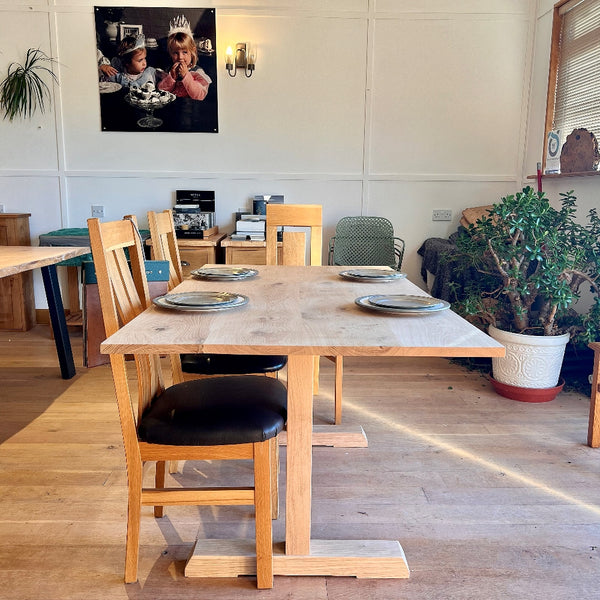 Handmade solid oak dining table with fine pillar base, crafted in Sussex end view