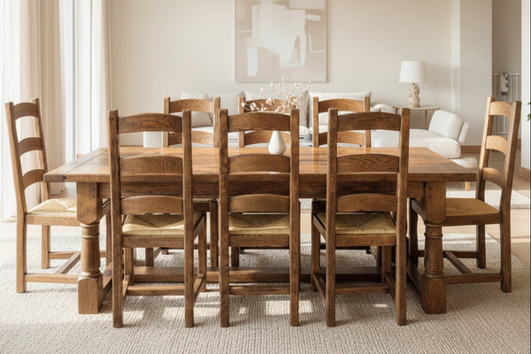 Handmade oak Refectory dining table with French oak ladderback chairs in a well-lit room