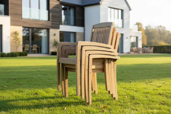 teak garden chairs stacked in garden in from of house