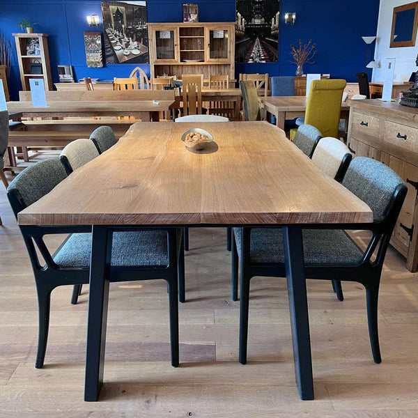 Handmade English Oak Dining Table with a powder coated steel base and a waney live edge oak top by Country Ways Oak Furniture Makers