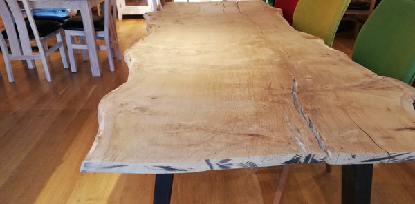 handmade rare high character burr oak  dining table with a rustic finish in Country Ways Oak Furniture  showroom with chairs 