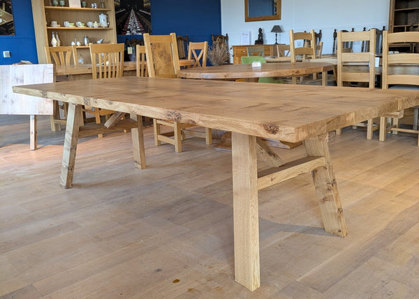 Contemporary  example of splayed leg dining table in country ways oak furniture showroom in pippy english oak