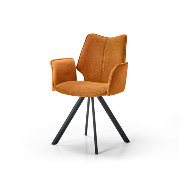 An upholstered accent chair with a warm orange-brown velvet fabric seat and backrest, featuring integrated armrests and a black metal swivel base, shown on a white background.