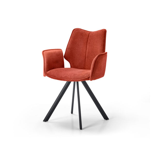 An orange-red upholstered dining chair with a high wingback backrest, integrated armrests, and four black metal legs, shown on a white background.