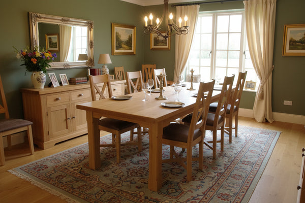 Crossback side chair with upholstered seat around an oak boarded refectory dining table in a dining room