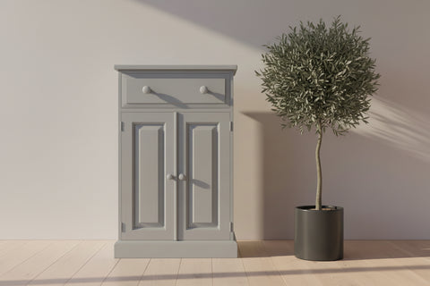 light grey painted pine cabinet against a plain wall