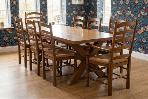 Extending solid oak cross leg dining table with 8 chairs in dining room
