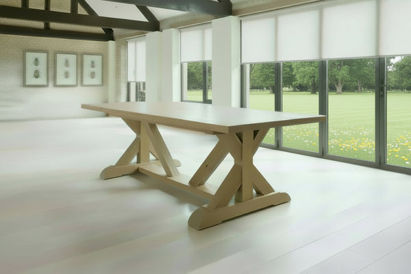 Cross braced oak dining table in a modern barn conversion with view over a wild flower meadow