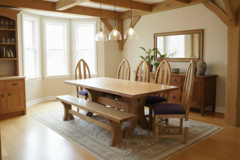 Handmade oak dining table with chairs and a bench in a dining room setting