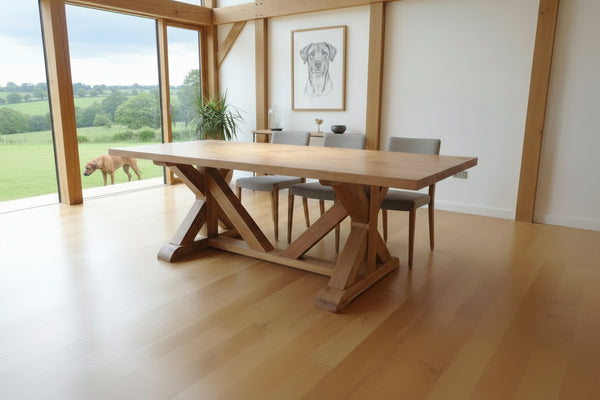 Cross braced oak dining table in a home in West Sussex with a Rhodesian Ridgeback in the garden