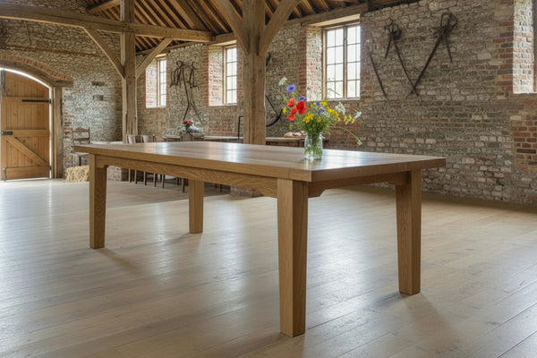 Large Sussex Farmhouse Oak Table in a large barn with a vase of flowers on table top