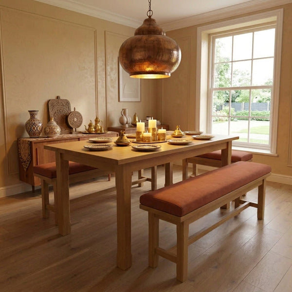 A handmade light oak dining table with matching benches in a London townhouse