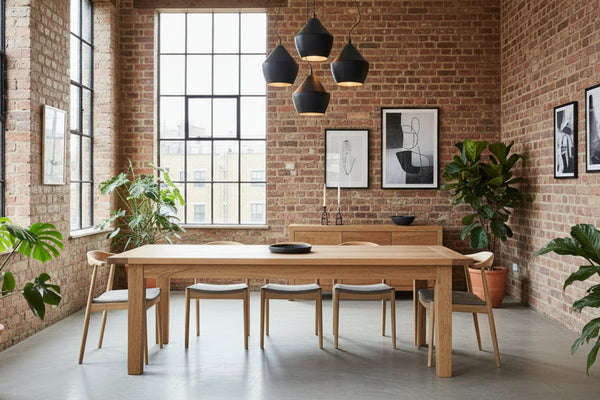 Sussex handmade farmhouse oak dining table in a trendy London apartment with modern wooden furniture