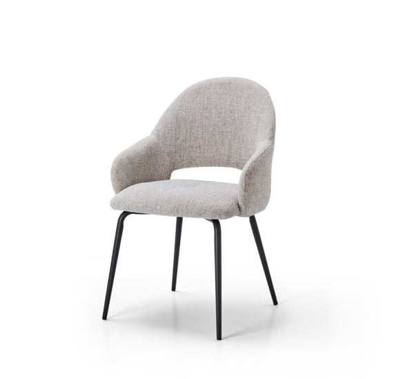 A modern upholstered dining chair with a curved back, integrated armrests, and a light beige textured fabric, supported by slim black metal legs, shown on a white background.