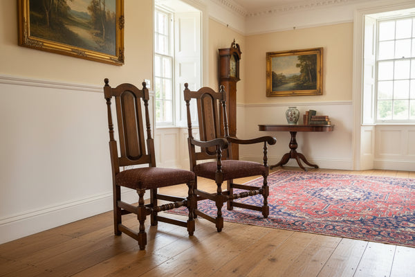 Two oak panel back chairs in a showroom setting