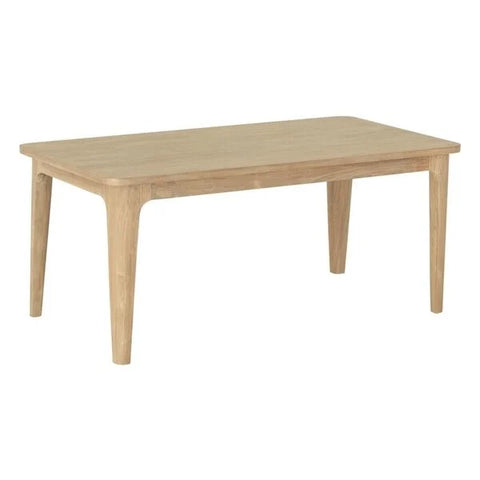 Reclaimed teak dining table with a light finish featuring curved edges and rounded tapered legs