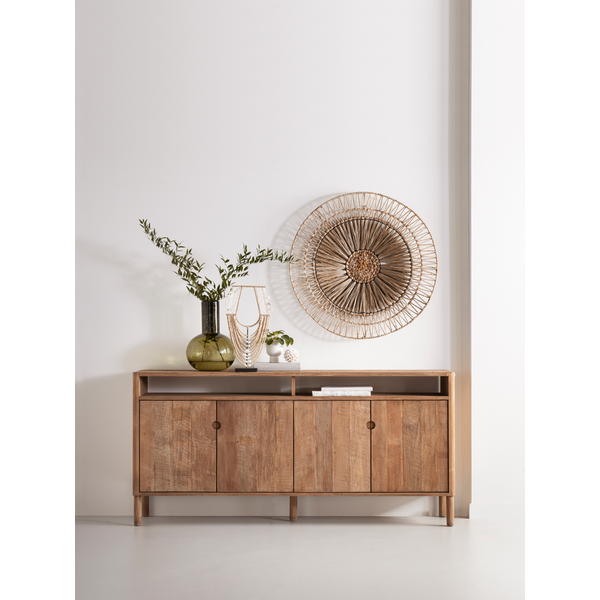 Wooden 4 door sideboard with decorative display items against a white wall