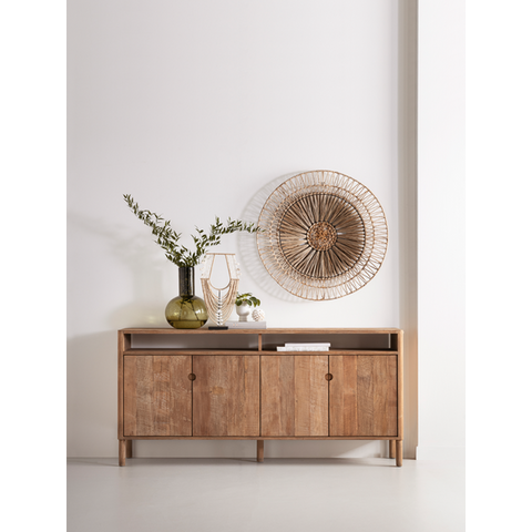 Wooden 4 door sideboard with decorative display items against a white wall