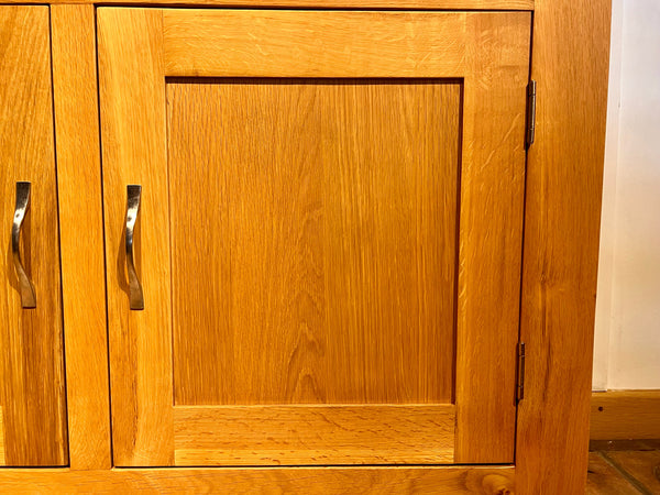 Close-up of Staplecross oak sideboard door and handle.