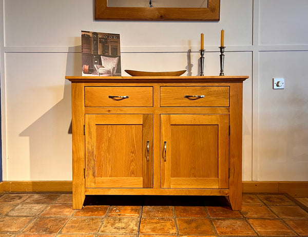 Staplecross oak sideboard with two drawers and two doors on a French antique terracotta tiled floor.