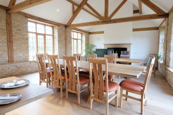 Sussex handmade oak cross leg extending table and Westfield dining chairs with leather upholstered seats in a Sussex Barn