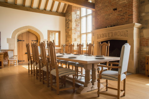 Handmade Twin Pillar dining table in character English oak in a grand country house dining room