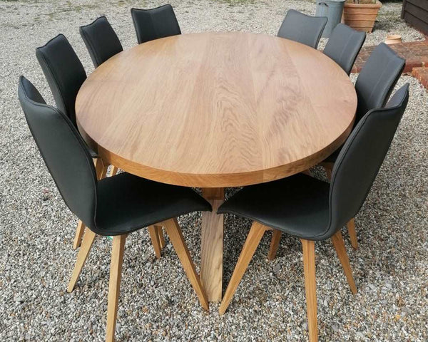 Sussex Contemporary Angled dining table with an oval top with a set of 8 leather upholstered Quad pod dining chairs