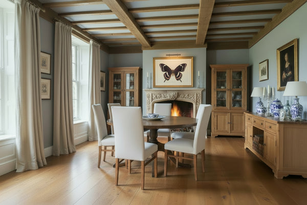 Round heavy pedestal dining table in a British country house dining room