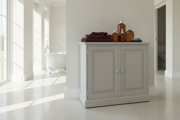 Bathroom with a painted pine cabinet, bathtub, and towels.