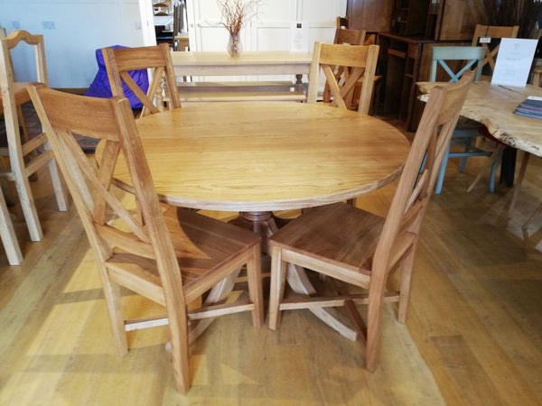 Extending oak pedestal dining table with chairs