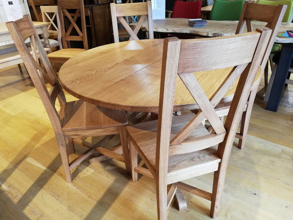Extending oak pedestal dining table unextended