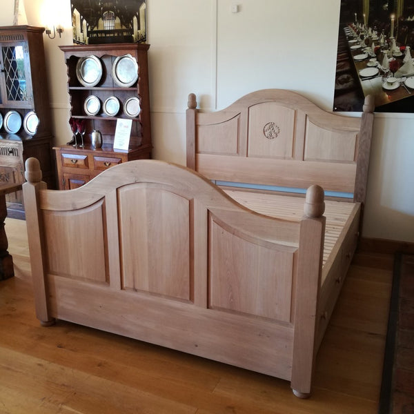 Grand Oak Bed with Storage in showroom