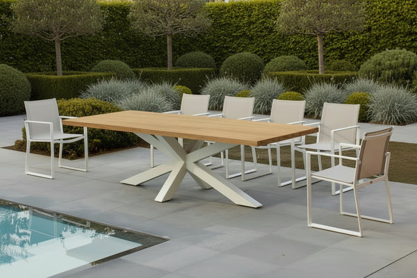 oak garden table in a modern garden with planting and pool